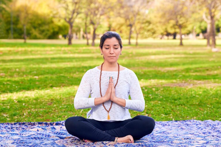 woman-doing-reiki-yoga-pose-park-chakra-pose